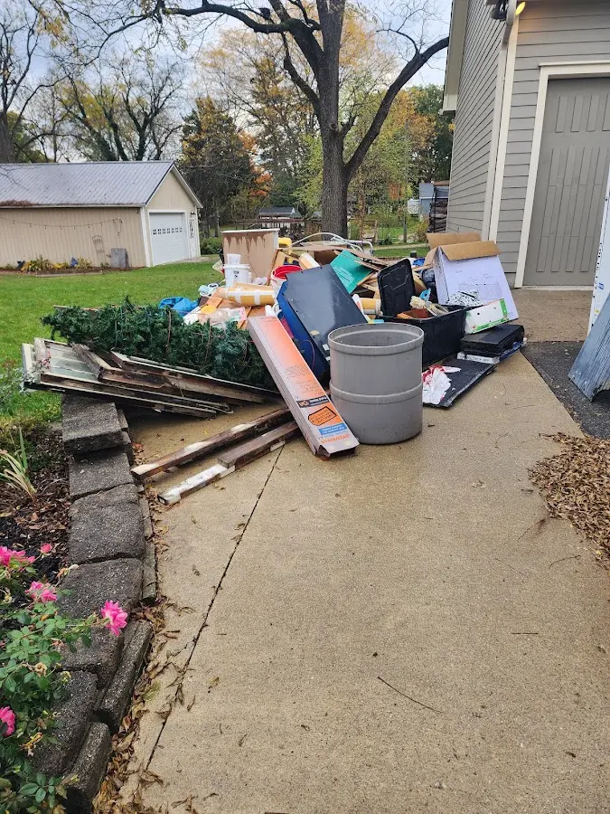 Dumpster being loaded with debris for Estate Cleanout Dumpster Rental in Stockbridge